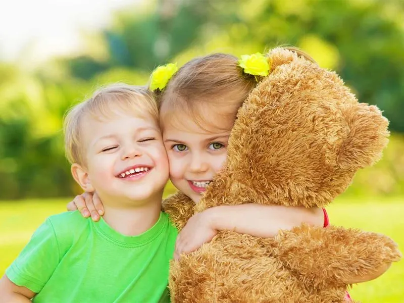 Young boy and girl holding a teddy bear