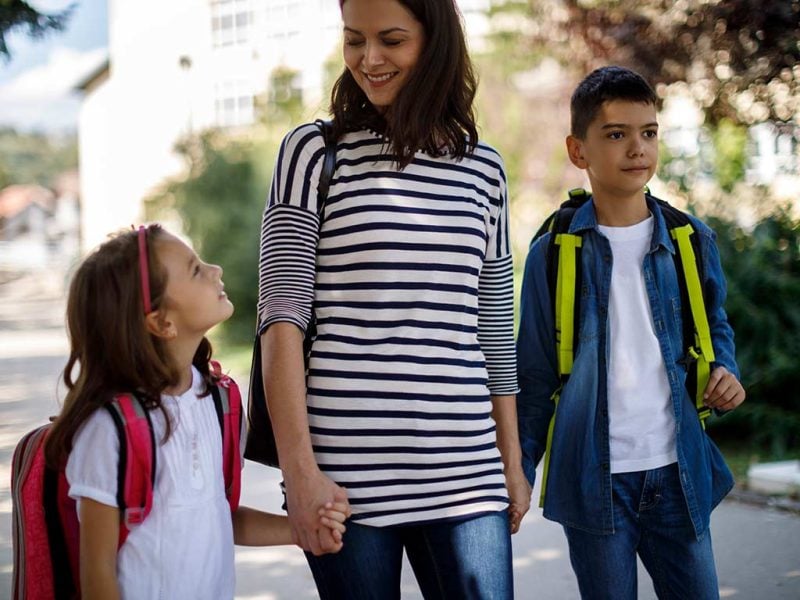 Woman walking with her two children