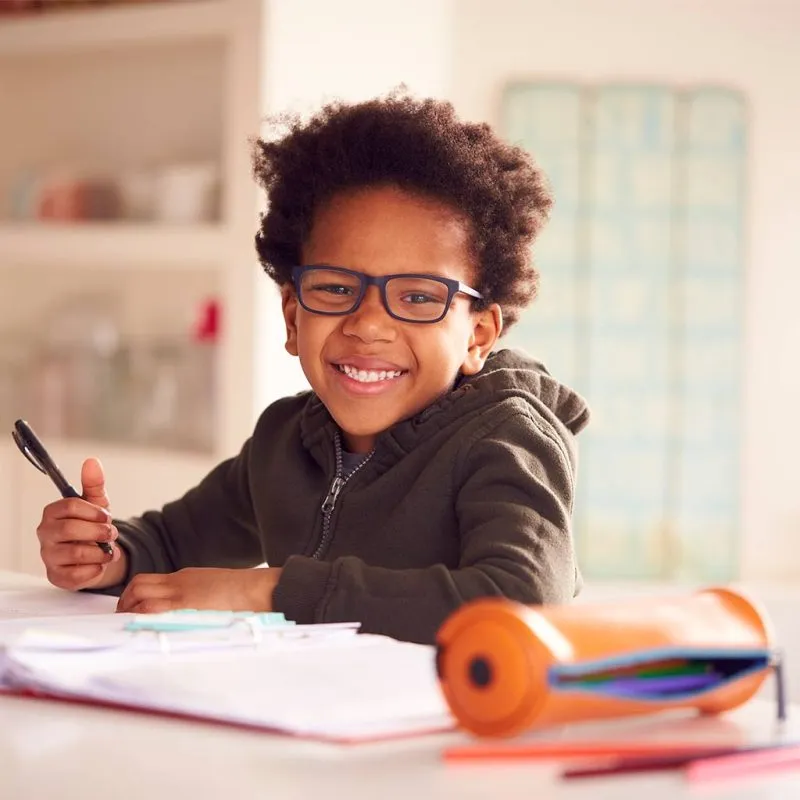 Young boy wearing glasses and smiling