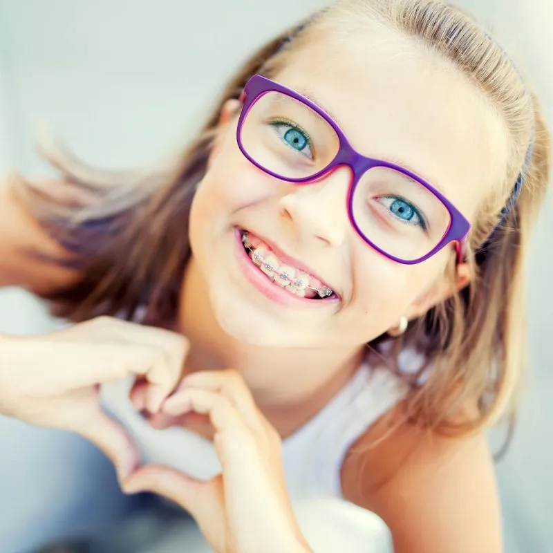 Young girl holding her hands in a heart shape