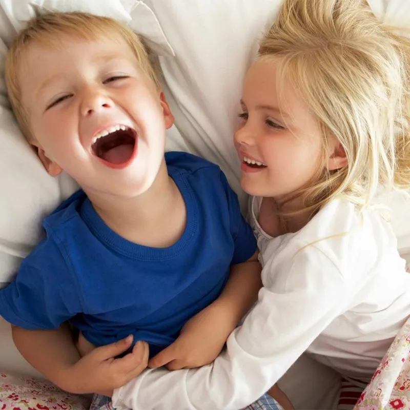 Young boy and girl laughing